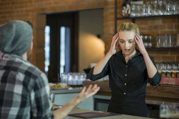 staff member feeling stressed with aggressive customer